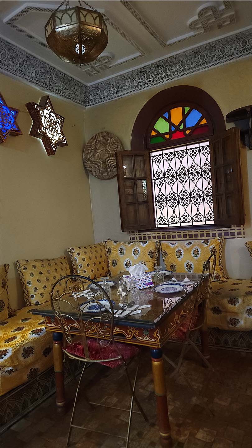 Entrance and seating area on the first floor of Benyamna Restaurant in Fes
